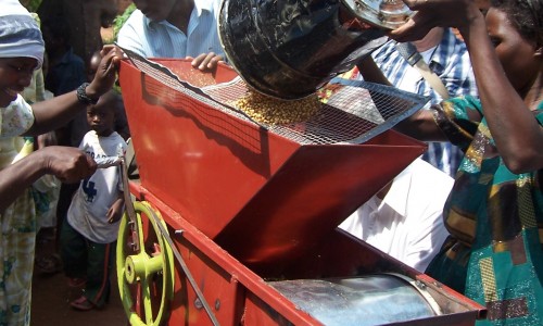 Michael Nabugere and farmers testing 2nd generation seed cleaner