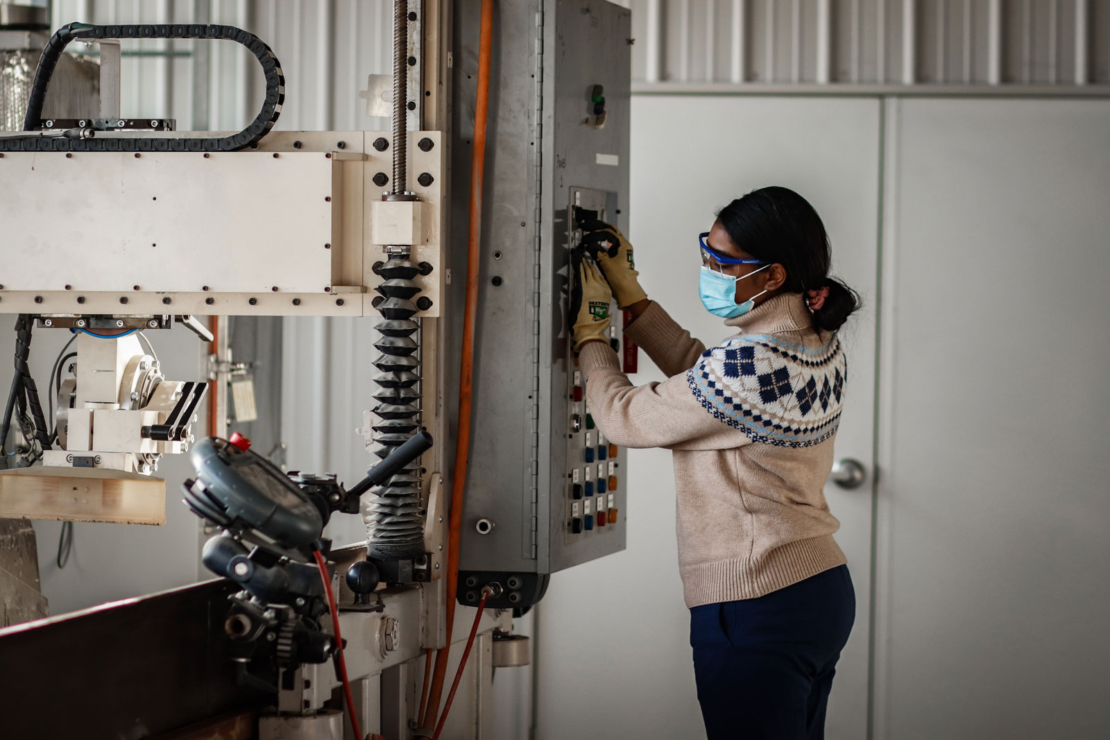 Female student works with equipment for a project
