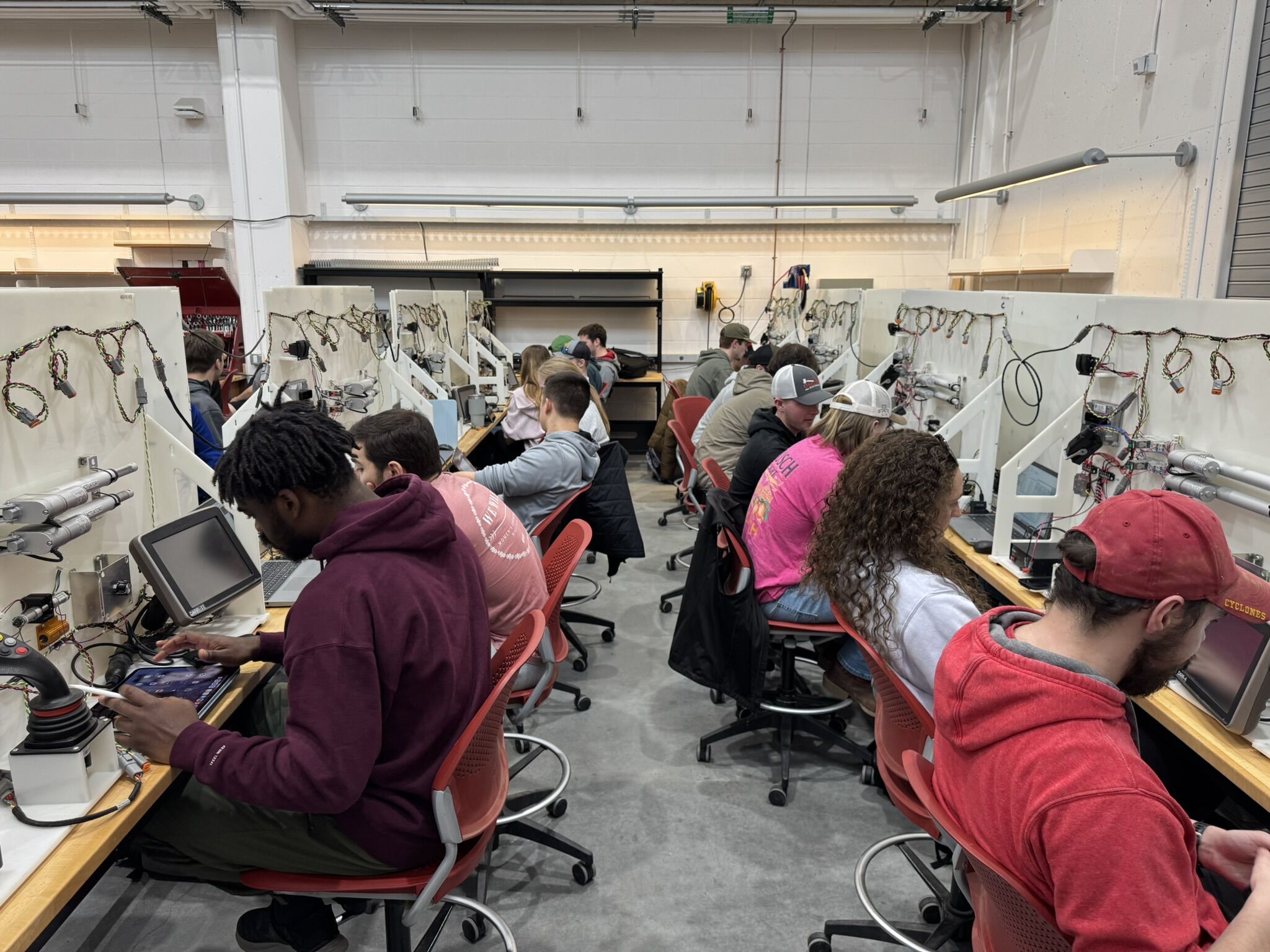 Students in ABE course working on system connection to tractor